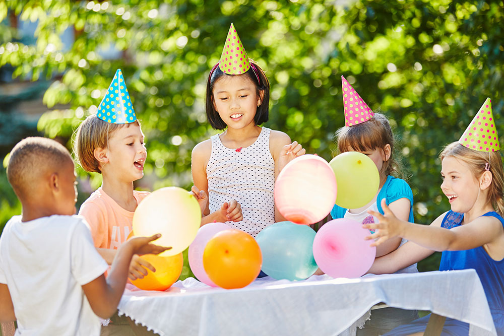 Birthday-parties-img young children celebrating birthday with balloons